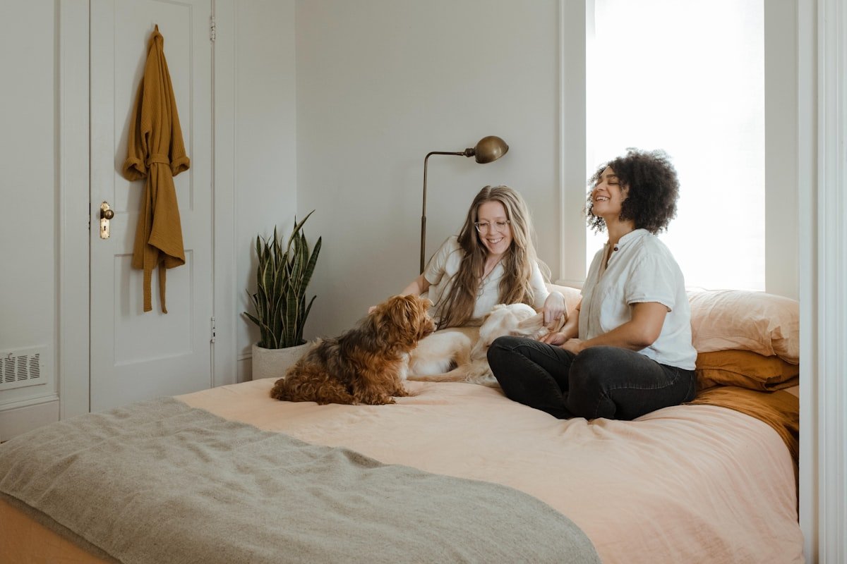 A relaxed pet owner at home on the sofa with their dog